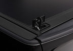 Close-up of Retrax 09-up Ram 1500 6.5ft Bed / 10-up Short Bed RetraxONE MX lock with key for security and convenience.