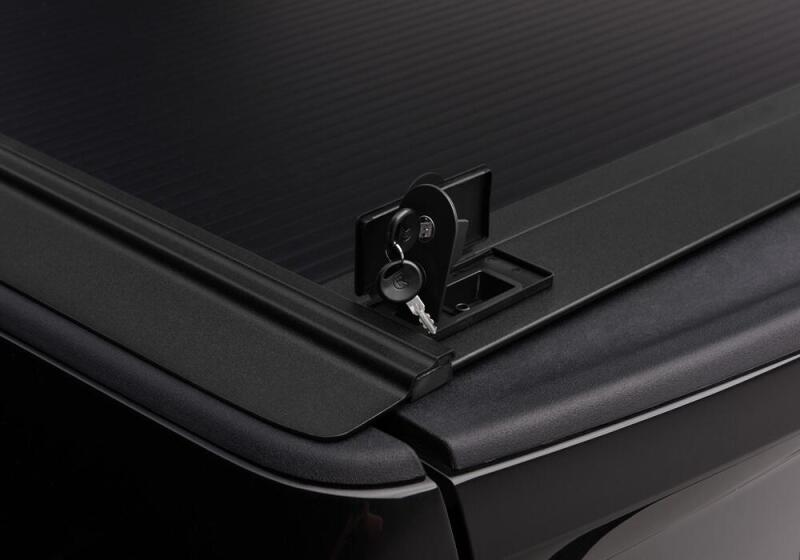 Close-up of Retrax 09-up Ram 1500 6.5ft Bed / 10-up Short Bed RetraxONE MX lock with key for security and convenience.