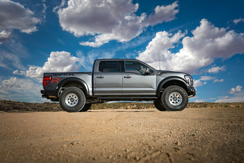 ICON 21-24 Raptor Triple Rate Overland Coil Spring Kit on a Ford F-150 Raptor, showcasing offroad performance and lift.