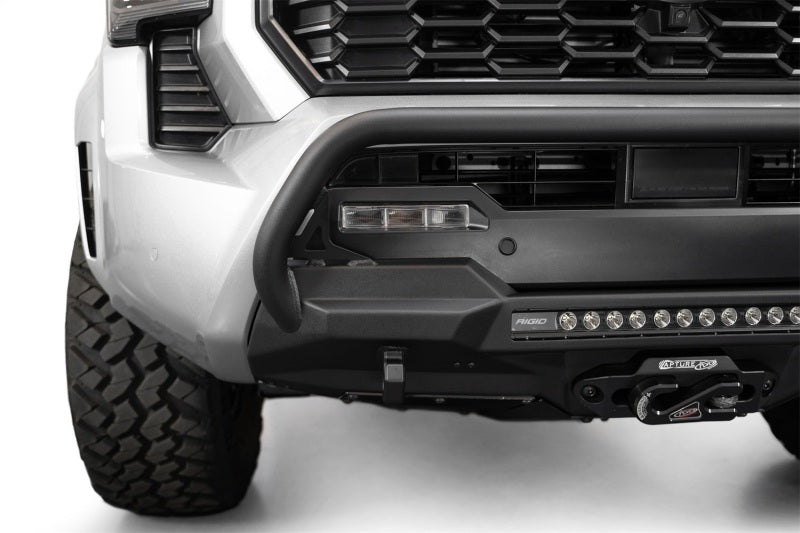 Addictive Desert Designs2024+ Toyota Tacoma Stealth Center Mount Winch Front Bumper w/ Top Hoop with winch and fog lights.
