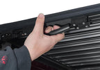 Hand using Retrax 19-22 Ram 1500 (5.5ft. Bed) Retrax IX Tonneau Cover