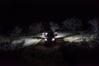 KC HiLiTES C-Series C2 LED 2in. Backup Area Flood Light 20w (Pair Pack System) - Black illuminating offroad scene at night.