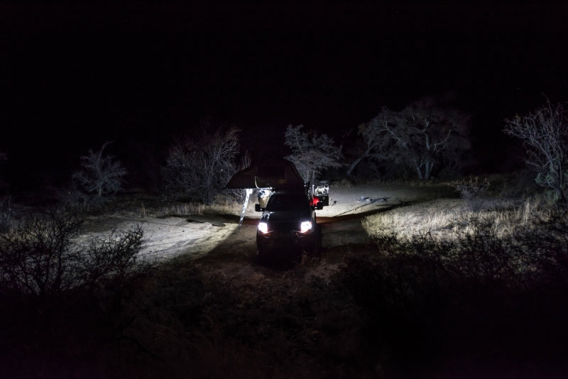 KC HiLiTES C-Series C2 LED 2in. Backup Area Flood Light 20w (Pair Pack System) - Black illuminating offroad scene at night.