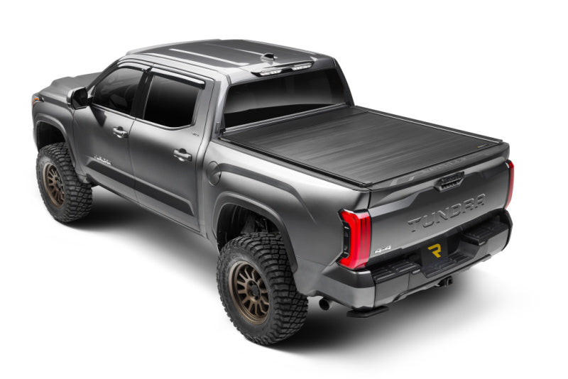 Retrax 2024 Ford F-150 SuperCrew/Super Cab 5.5ft. Bed Retrax EQ on a truck with offroad wheels and tires.
