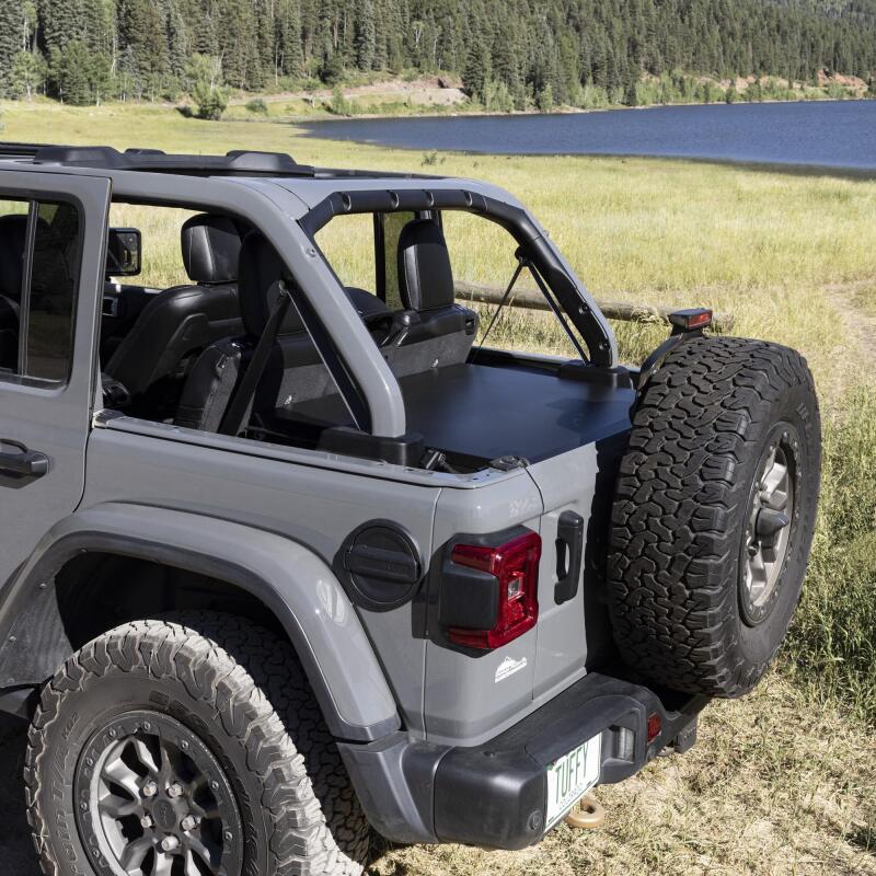 Tuffy Deluxe Enclosure For Jeep Wrangler W/ Subwoofer in off-road setting