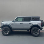 Camburg Ford Bronco 21-23 1.25in Performance Uniball Upper Arms (w/Covers) installed on a lifted truck with offroad tires.