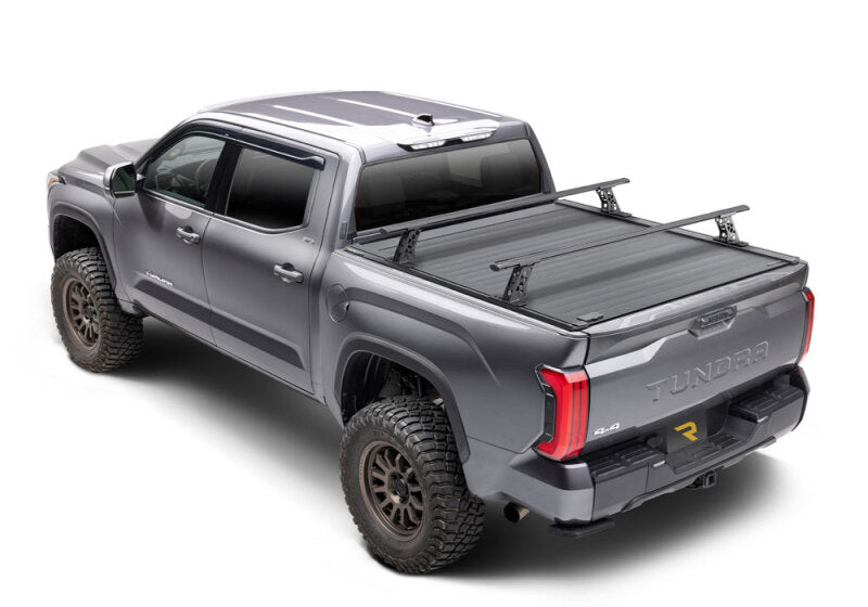 Retrax 2007-2020 Toyota Tundra CrewMax 5.5ft Bed RetraxPRO XR with Deck Rail System on a lifted truck.
