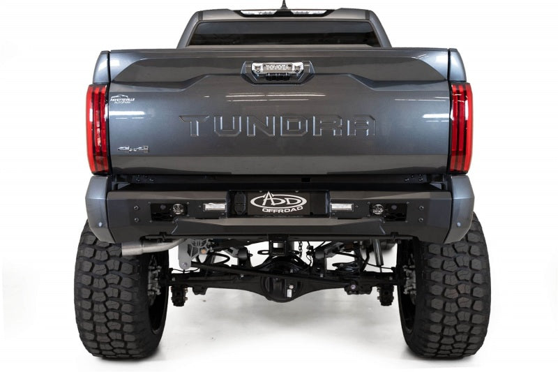 Addictive Desert Designs 22-23 Toyota Tundra Stealth Fighter Winch Rear Bumper on offroad truck with upgraded tires and suspension.