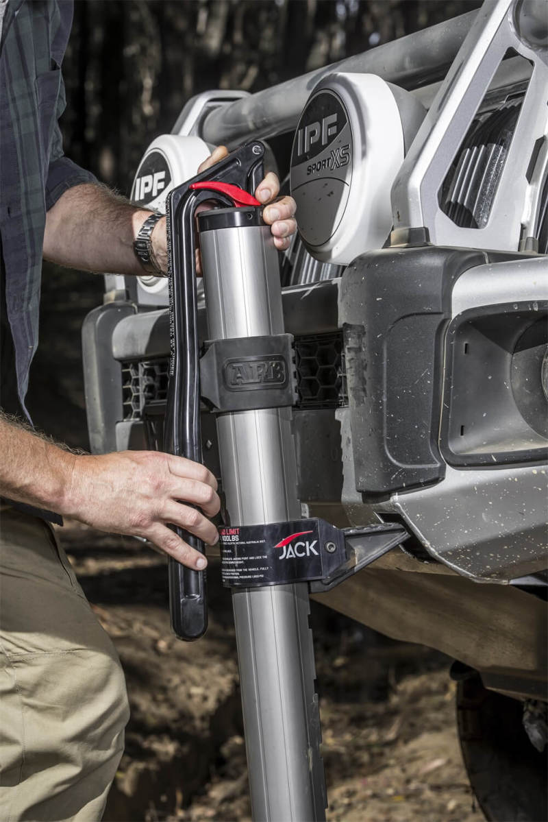 Person using ARB Hydraulic Recovery Jack for off road recovery.