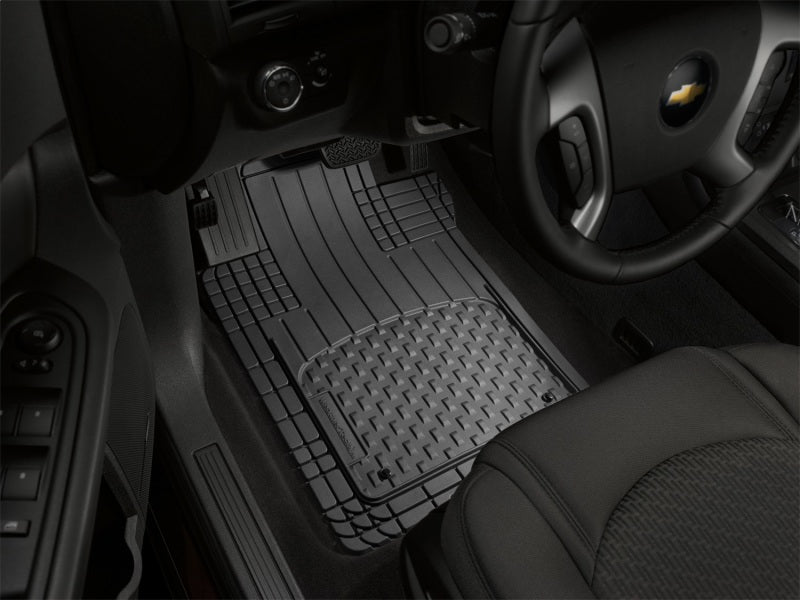 WeatherTech Front and Rear Heavy Duty AVM - Black floor mat in a vehicle.
