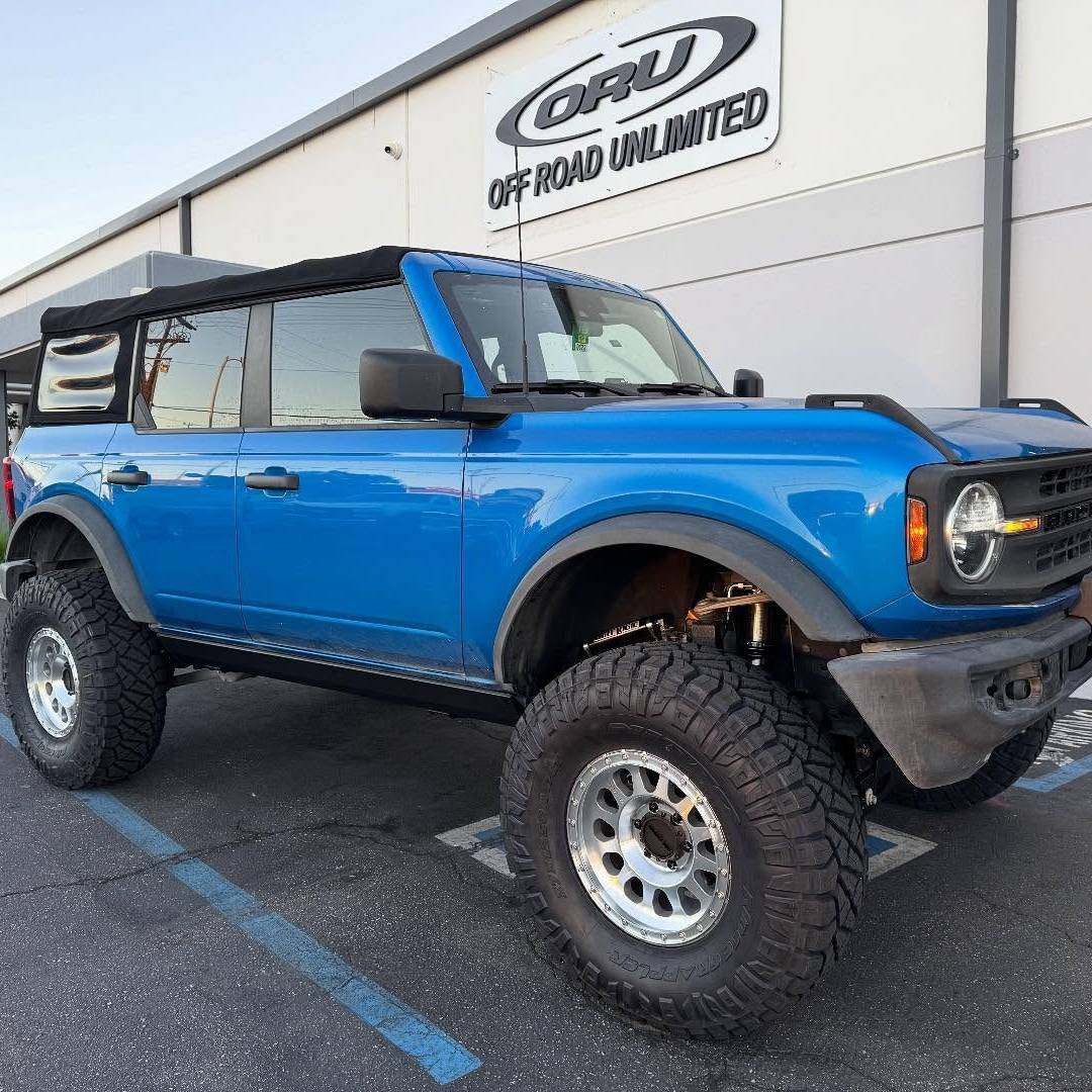 Blue offroad vehicle showcasing ORU brand parts and suspension upgrades.