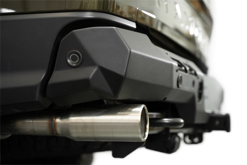 Addictive Desert Designs2024+ Ford Ranger Raptor Phantom Rear Bumper close-up with tow hitch and exhaust.