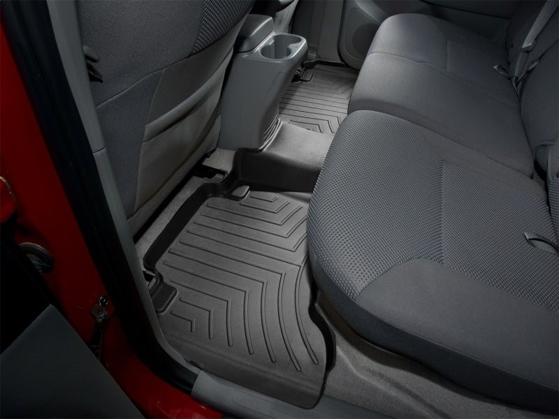 WeatherTech 05-13 Toyota Tacoma Double Cab Rear FloorLiner - Black installed in truck interior.