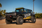 ICON 21+ Ford Bronco Tubular Upper Control Arm Delta Joint Kit with offroad tires and lighting.