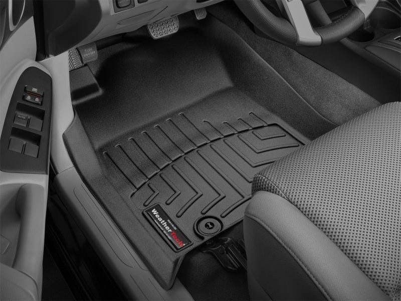 WeatherTech 12-14 Toyota Tacoma Front FloorLiners - Black in a truck interior, perfect fit and durable protection.