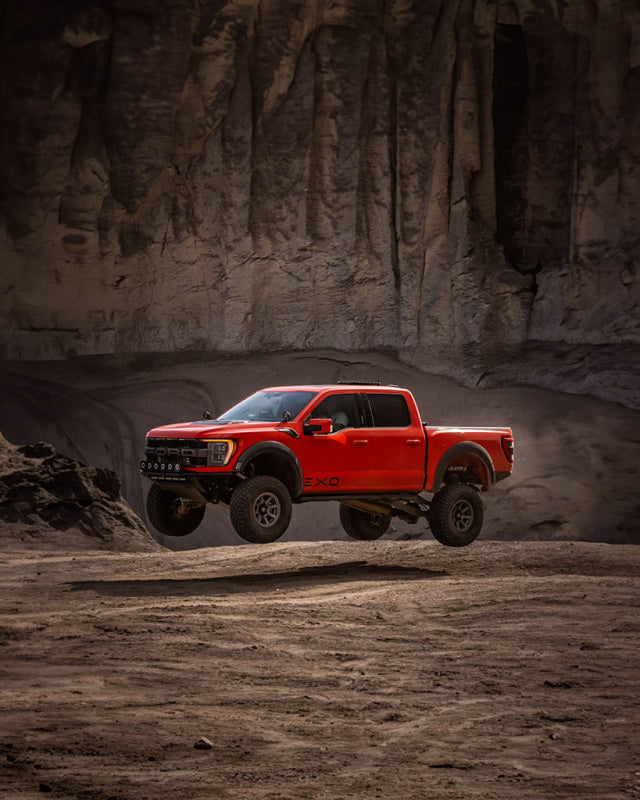 ICON Rebound Pro 17x8.5 6x135 6mm Offset 5in BS 87.1mm Bore Titanium Wheel on offroad truck jumping over sand