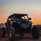 Rigid Industries Revolve 10in Bar w/Amber Trim Ring on offroad vehicle at sunset