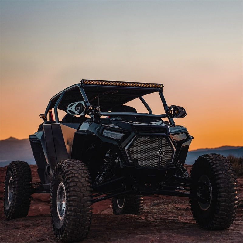Rigid Industries Revolve 50in Bar w/Amber Trim Ring on offroad vehicle at sunset