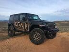 ICON 2018+ Jeep Wrangler JL 2.5in Stage 3 Suspension System with offroad wheels in rugged terrain.