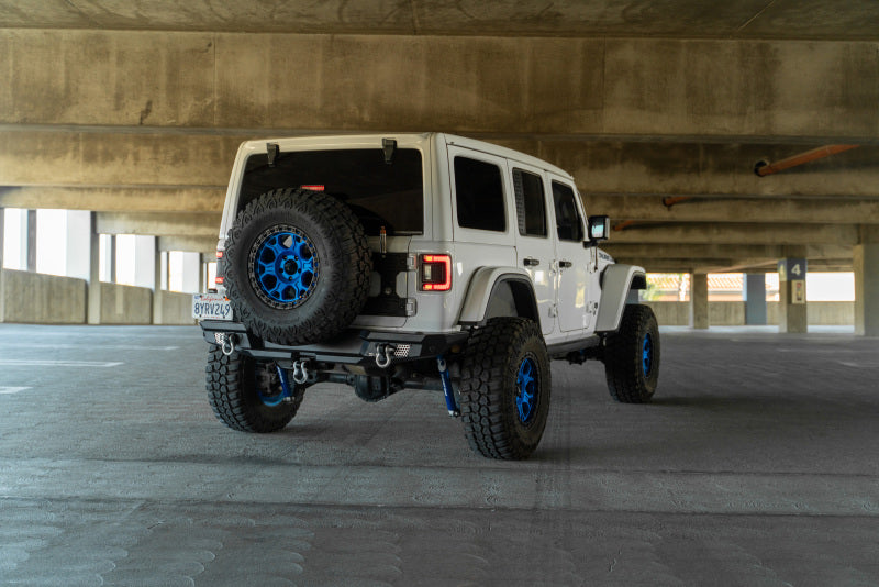 DV8 Offroad 2018 Jeep Wrangler JL MTO Series Rear Bumper w/ Optional Tire Carrier in parking garage.