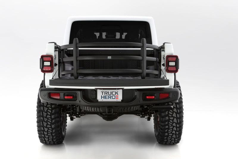 AMP Research 20-22 Jeep Gladiator (Does Not Work w/Tonneau Cvrs) Bedxtender HD Sport - Black on truck with offroad tires