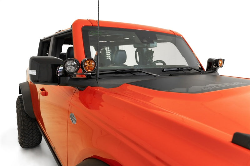 Addictive Desert Designs21-23 Ford Bronco/Raptor Dual Ditch Light Brackets mounted on offroad truck for enhanced lighting.