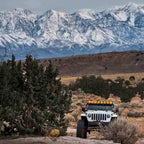KC HiLiTES Gravity Titan LED 6in. - Pair Pack (SAE Driving Beam) on Jeep in offroad nature setting.