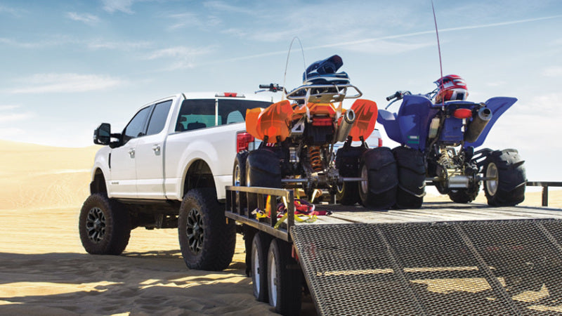 Air Lift Universal Air Spring Cradle on lifted truck with ATVs