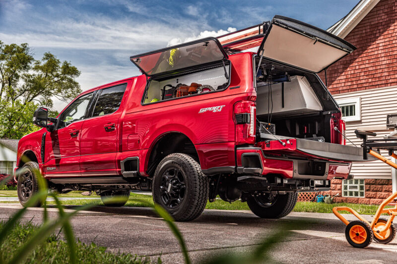 AMP Research 2023 Ford F-250 Super Duty BedStep - Black on red truck