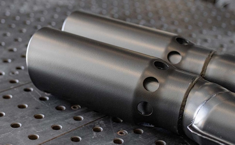 MagnaFlow 07-10 Dodge 2500/3500 409 SS DPF Back 5in Single Exit Exhaust- Black close-up view of black exhaust tips.
