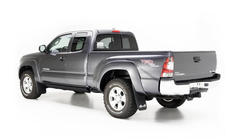 AMP Research 2016-2017 Toyota Tacoma Double Cab/Access PowerStep - Black on gray truck with offroad tires.