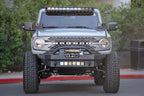 DV8 Offroad 21-22 Ford Bronco Front Lower Control Arm Skid Plate on lifted Bronco with offroad lighting