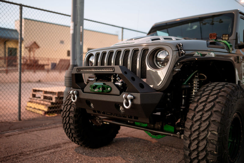 DV8 Offroad 18-22 Jeep Gladiator Wrangler LED Projector Headlights with custom bumper and offroad wheels.