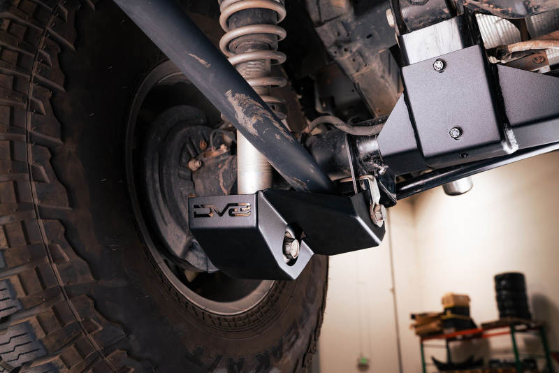 DV8 Offroad 2021-2022 Ford Bronco Rear Shock Guard Skid Plates close-up view on offroad suspension.