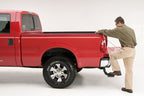 AMP Research 1999-2016 Ford F-250/350/450 BedStep - Black in action on a red truck.