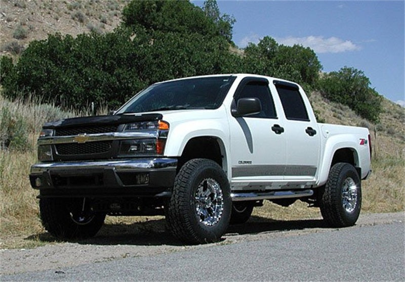 Tuff Country 04-12 Chevy Colorado 4x4 4in Lift Kit (SX8000 Shocks) on offroad truck with custom wheels.