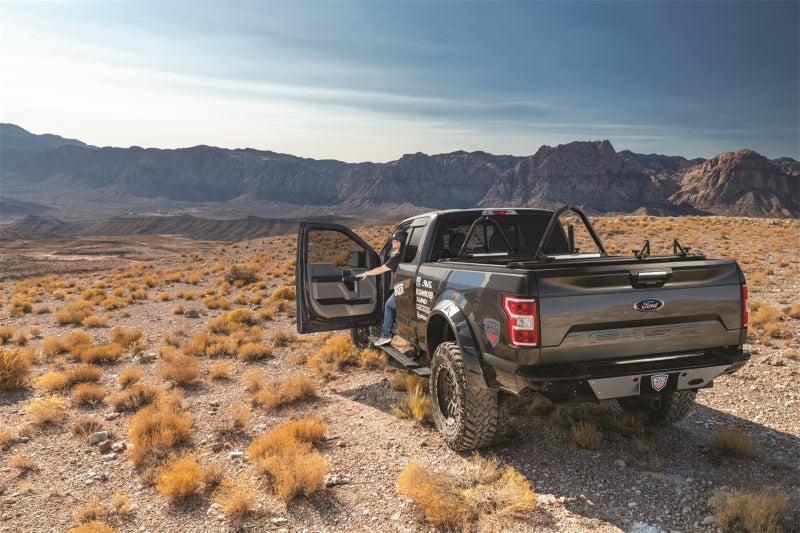 AMP Research 15-20 Chevy/GMC Silverado 2500-3500/Sierra 2500-3500/Crew & Double Cab PowerStep on an off-road truck.