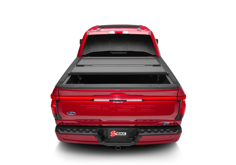 BAK 21-22 Ford F-150 (Incl. 2022 Lightning) BAKFlip MX4 5.7ft Bed Cover - Matte Finish on red truck