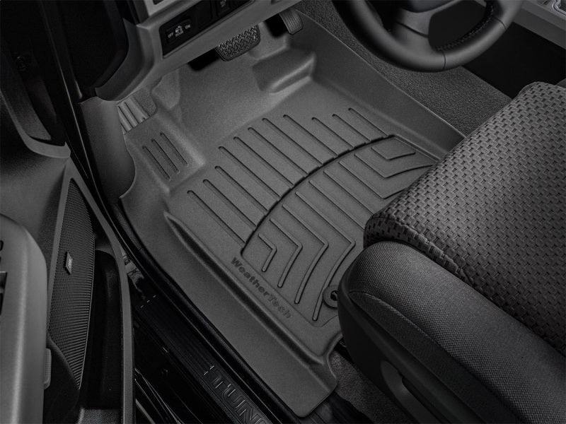 WeatherTech 12-21 Toyota Sequoia Front FloorLiner HP - Black in vehicle footwell, providing superior protection for carpets.