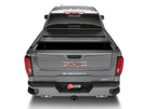 BAK 2020 Chevy Silverado 2500/3500 HD 6ft 9in Bed BAKFlip F1 truck bed cover from rear view with BAK logo
