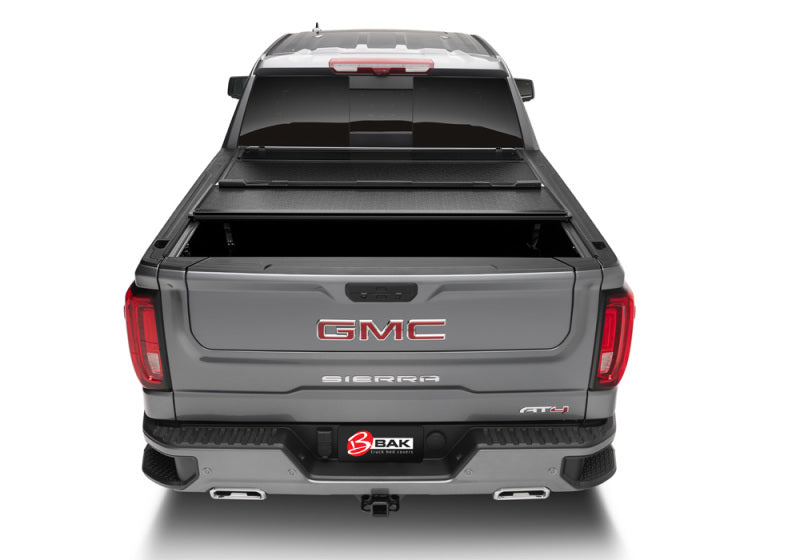 BAK 2020 Chevy Silverado 2500/3500 HD 6ft 9in Bed BAKFlip F1 truck bed cover from rear view with BAK logo