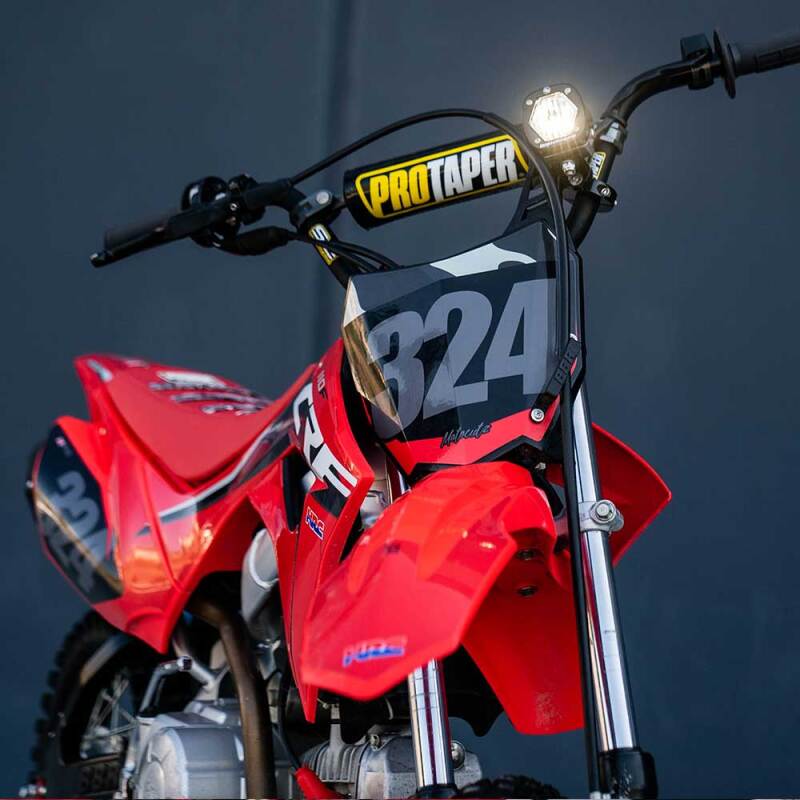 Baja Designs S1 Wide Cornering Electric Start Pit Bike LED Light on a red dirt bike Main image