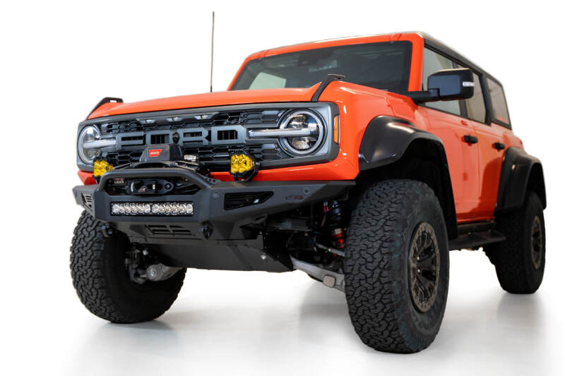 Addictive Desert Designs 22-23 Ford Bronco Raptor Rock Fighter Skid Plate on rugged offroad truck with performance upgrades.