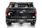 Addictive Desert Designs17-20 Ford F-150 Raptor Phantom Front Bumper on a black Ford truck with offroad accessories.