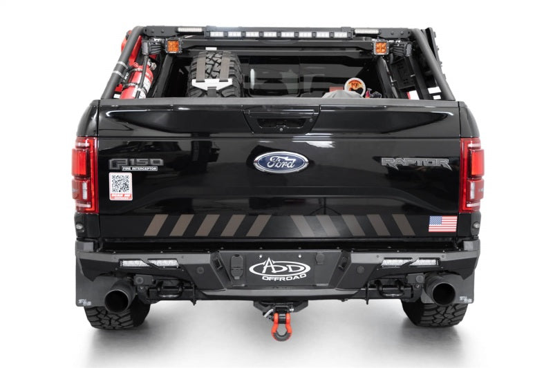 Addictive Desert Designs17-20 Ford F-150 Raptor Phantom Front Bumper on a black Ford truck with offroad accessories.