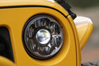 KC HiLiTES 07-18 Jeep JK 7in. Gravity LED Pro DOT Approved Replacement Headlight (Single) on a yellow Jeep.