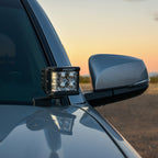 Rigid Industries 16-20 Toyota Tacoma A-Pillar Light Kit w/D-SS Flood mounted on truck side mirror
