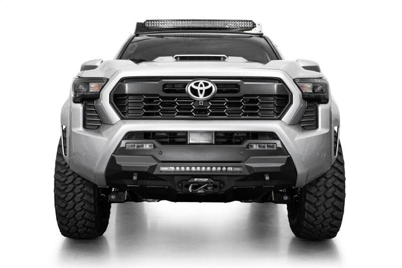 Addictive Desert Designs 2024 Toyota Tacoma Stealth Center Mount Winch Front Bumper with offroad lighting and aggressive design.