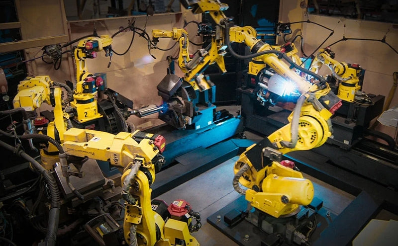 Industrial robotics: automated yellow robotic arms in action.