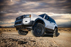 ICON 2024+ Toyota Land Cruiser 250 Series Front 2.5 VS IR Coilover Kit on off-road terrain.